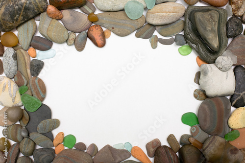 Sea pebbles frame on white background