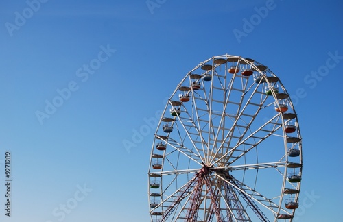 Ferris wheel on background blue sky