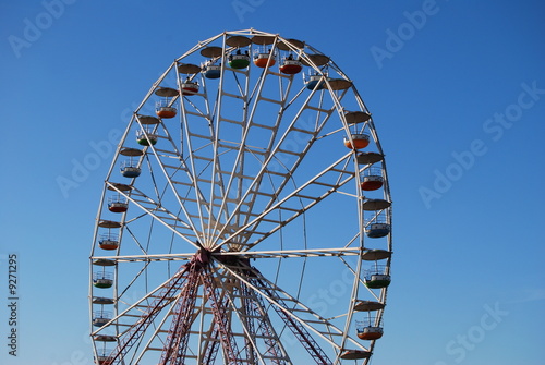 Ferris wheel on background blue sky
