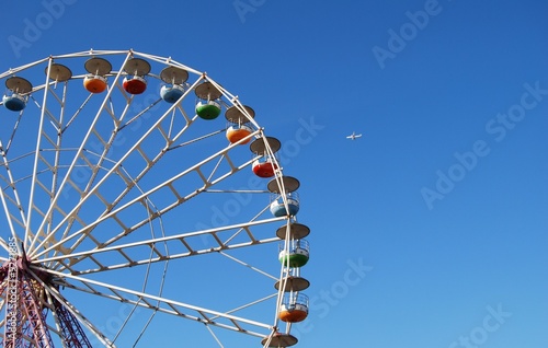Ferris wheel on background blue sky