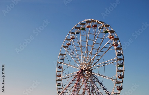 Ferris wheel on background blue sky