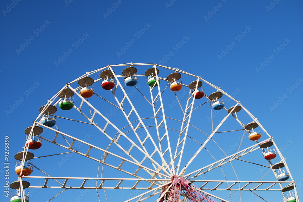 Ferris wheel on background blue sky