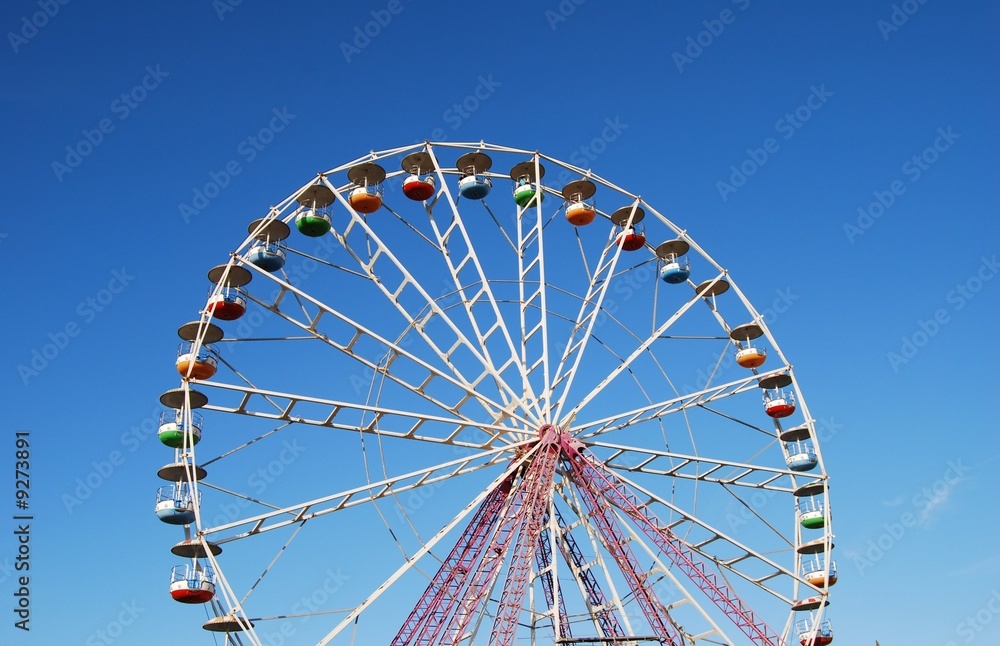 Ferris wheel on background blue sky