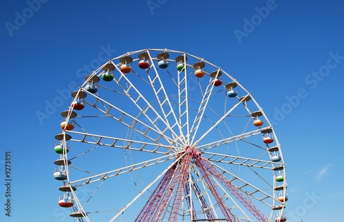 Ferris wheel on background blue sky