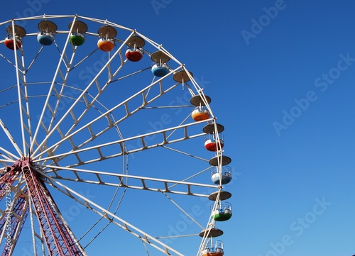 Ferris wheel on background blue sky