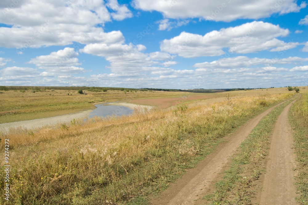 view of rural locality with a river and clouds in the background