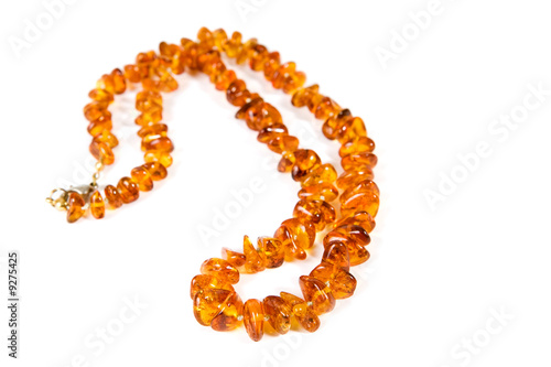 Amber necklace on blue background