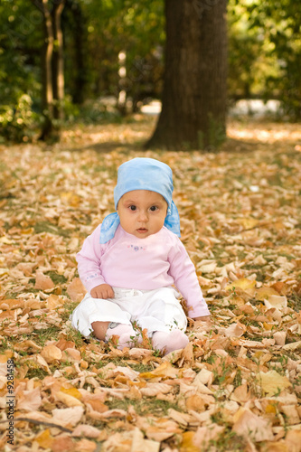 Little baby sitting comfort in park.