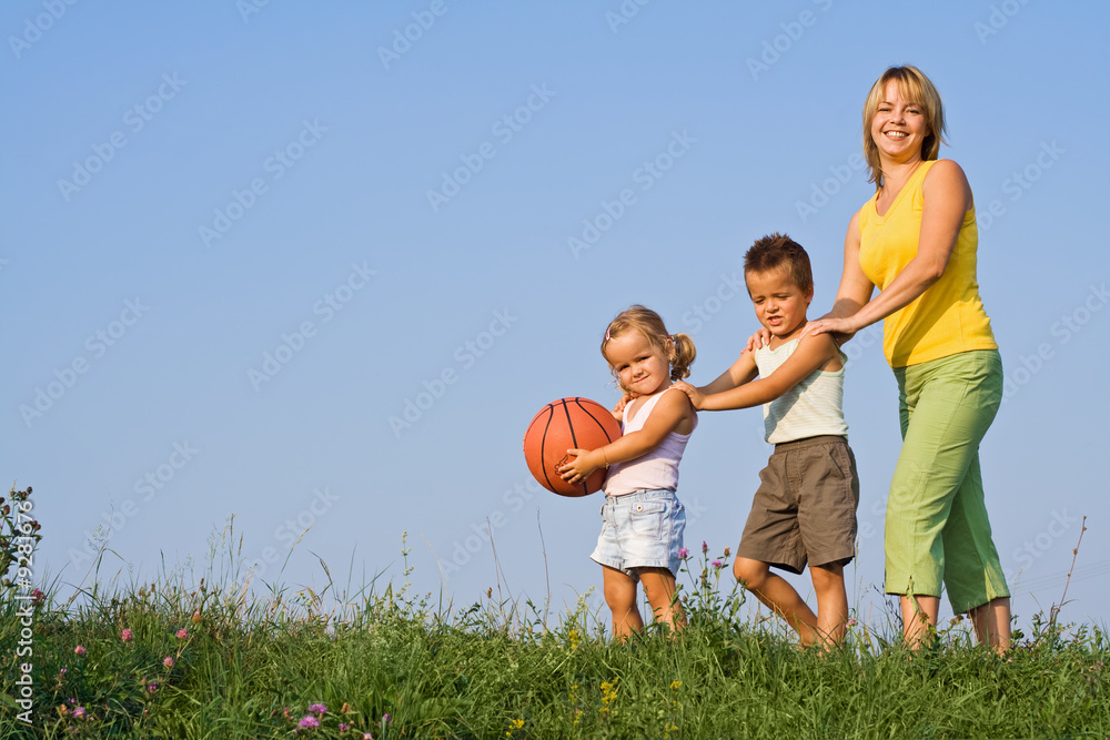 Woman and kids having fun together outdoors in summertime Woman and kids having fun together outdoors in summertime