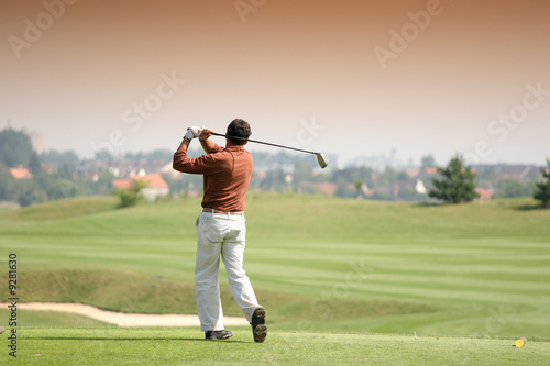 Golfer in bussy saint georges hole 7, france, hitting shot