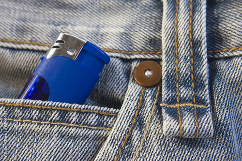Blue lighter in washed, stylish jeans pocket