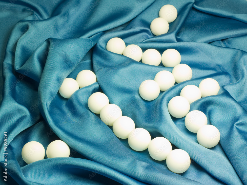Ping pong balls on blue fabric Ping pong balls on blue fabric