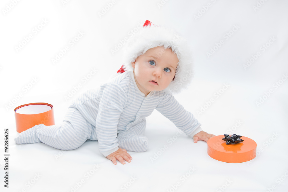 little, cute baby boy wearing Christmas hat, on white little, cute baby boy wearing Christmas hat, on white