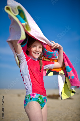 Young girl smiling with beach towel photo