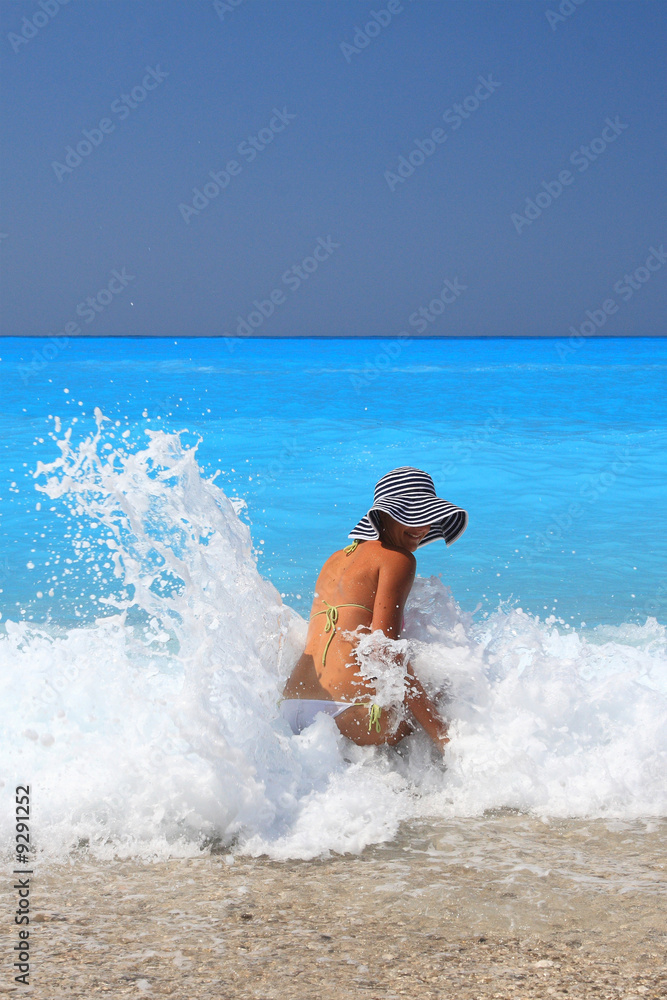 Pretty blonde woman enjoying the Ionian sea in Greece