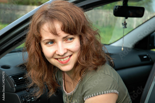 Portrait of the lovely girl in the car
