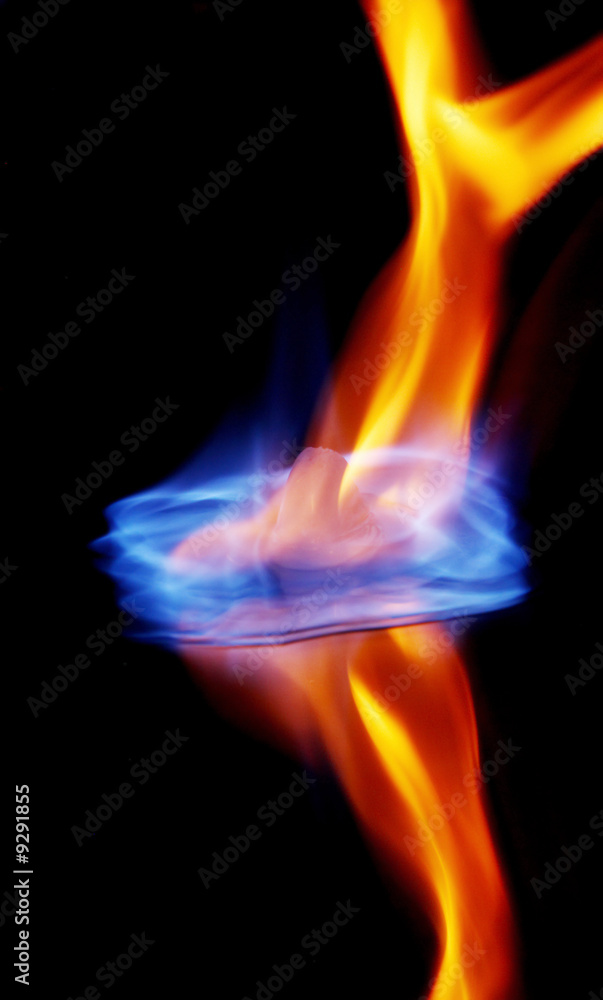 Blue flames burning ice cube and its reflection