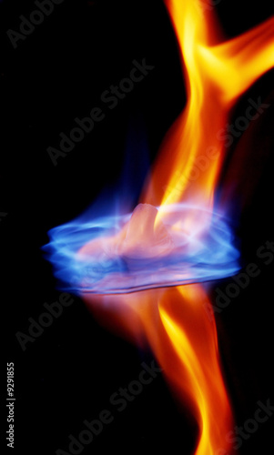 Blue flames burning ice cube and its reflection