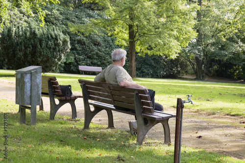 Senior man relax on a bench in park.