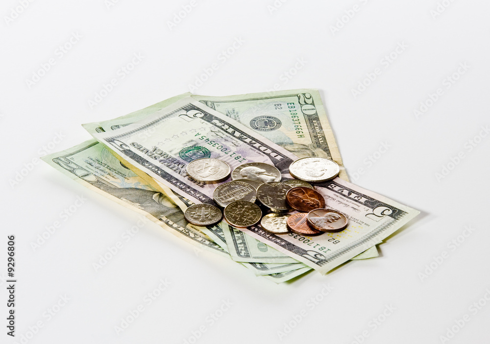 Stack of loose change on a pile of twenty and five dollar bills Stack of loose change on a pile of twenty and five dollar bills