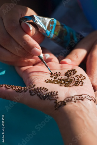 A temporary henna tattoo applied by an artist