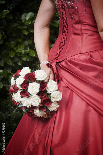 Back of bride's red wedding dress and bouquet