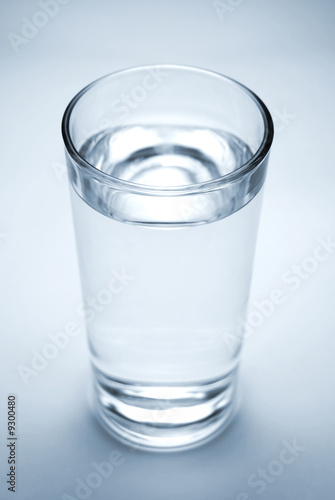 Fresh cool glass of water on a blue background