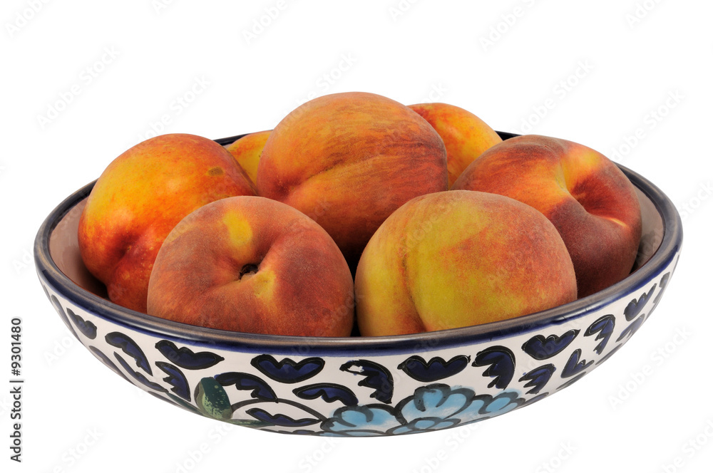 Peaches on hand painted plate, isolated on white. Peaches on hand painted plate, isolated on white.