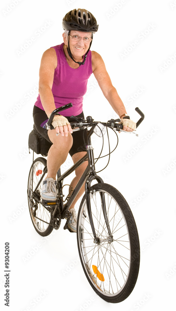 Smiling Fit Senior Woman Riding a Bicycle Smiling Fit Senior Woman Riding a Bicycle