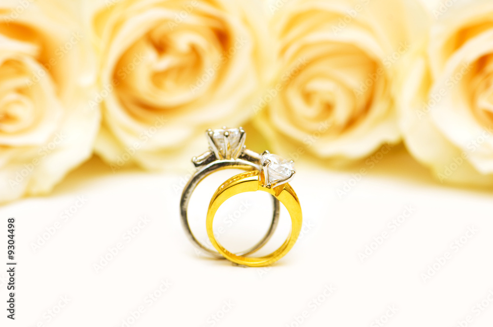 Diamond rings and roses isolated on the white Diamond rings and roses isolated on the white