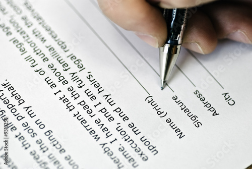 hand with pen makes signature on agreement