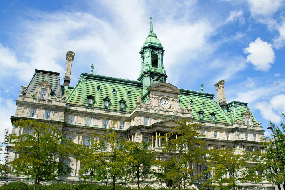 Fototapeta premium The old Montreal city hall (hotel de ville) on a cloudy day