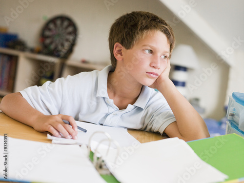 Young Boy Doing Homework In His Room