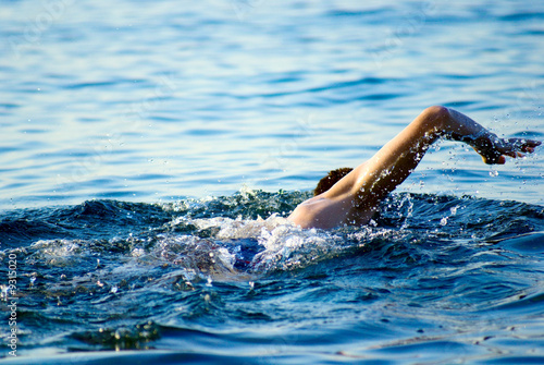 swimming man in ocean water