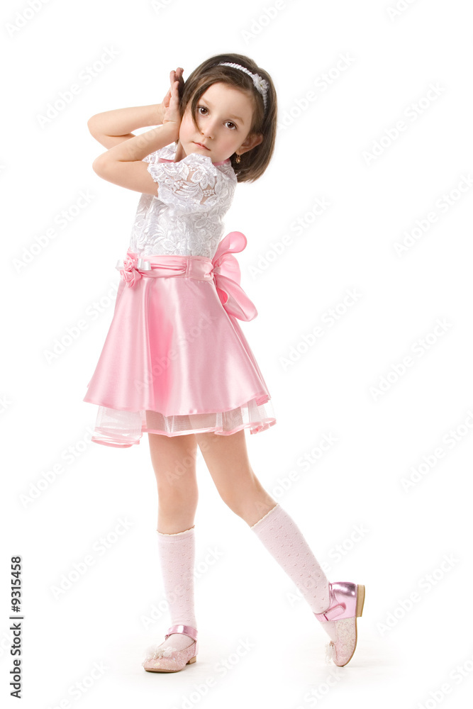 The lovely little girl posing in a beautiful pink dress. The lovely little girl posing in a beautiful pink dress.
