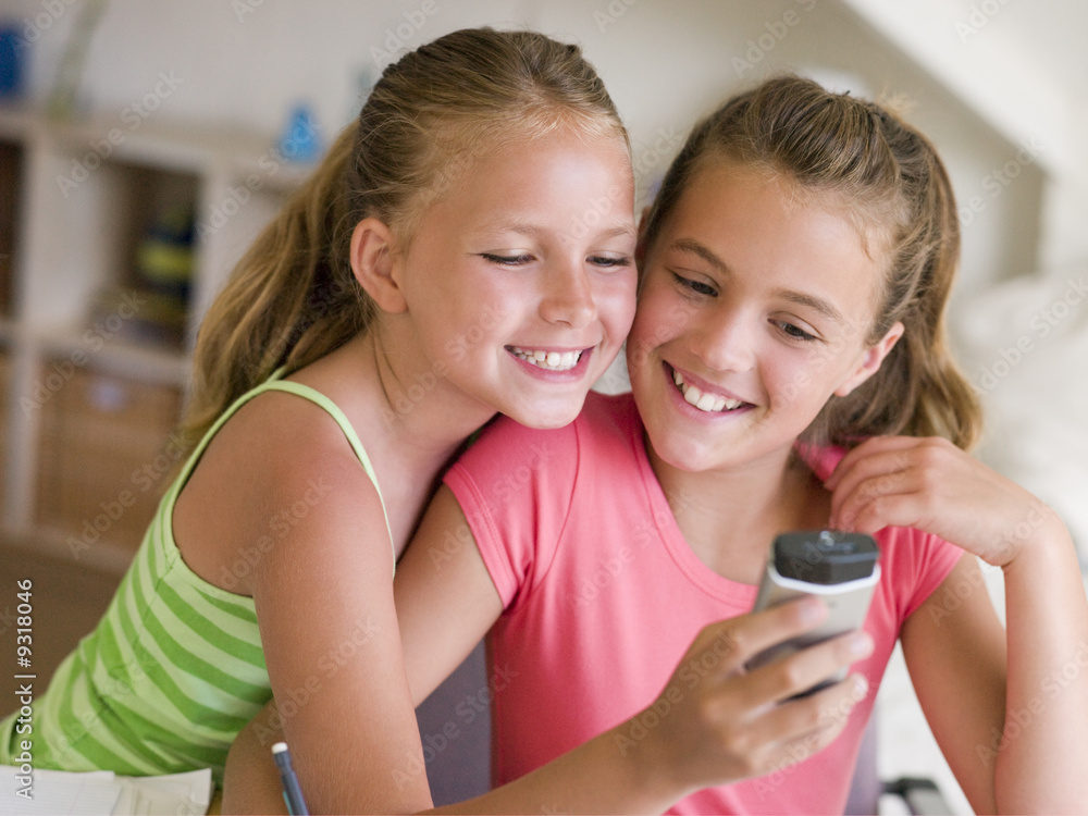 Young Girls Playing With A Cellphone Young Girls Playing With A Cellphone