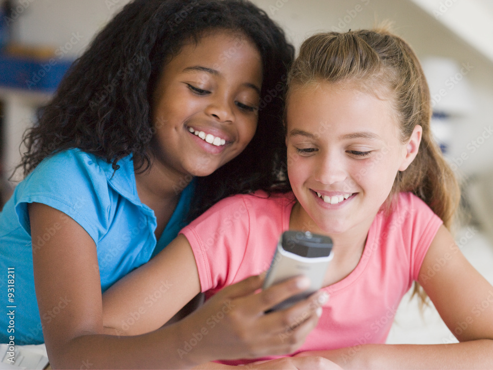 Young Girls Playing With A Cellphone Young Girls Playing With A Cellphone