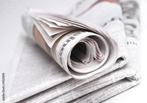 Newspapers on light background