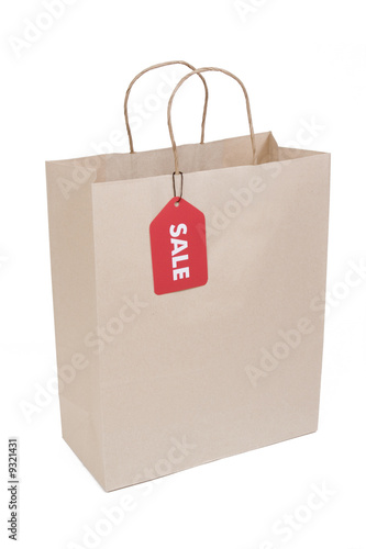Shopping bag isolated on white with red SALE tag