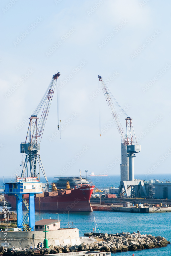Cargo ship under loading in the Port of Livorno