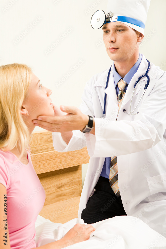 Portrait of young pretty woman being examined by doctor Portrait of young pretty woman being examined by doctor