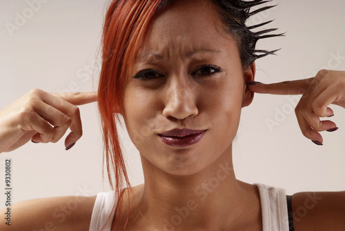 young woman put finger in her ears