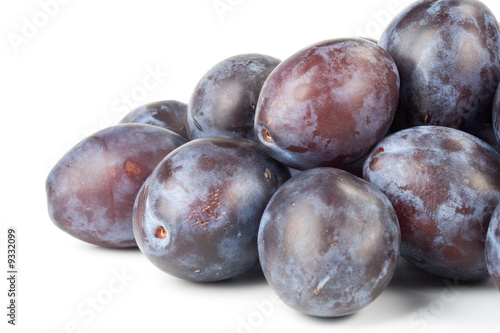 Fresh appetizing plums on a white background