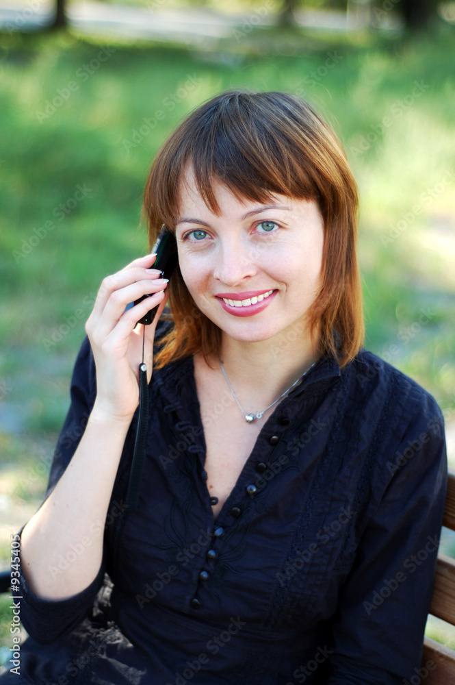 Young pretty woman making a call by cellphone Young pretty woman making a call by cellphone