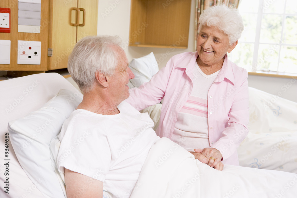 Senior Woman Visiting Her Husband In Hospital Senior Woman Visiting Her Husband In Hospital