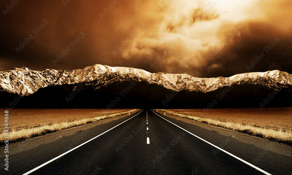 Leinwandbild Motiv - Kwest : Long straight road heading to stormy mountains