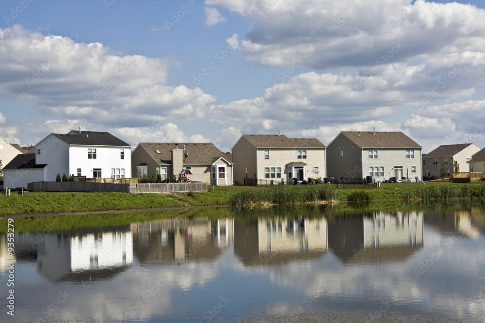 Suburban community reflected in the pond. Suburban community reflected in the pond.