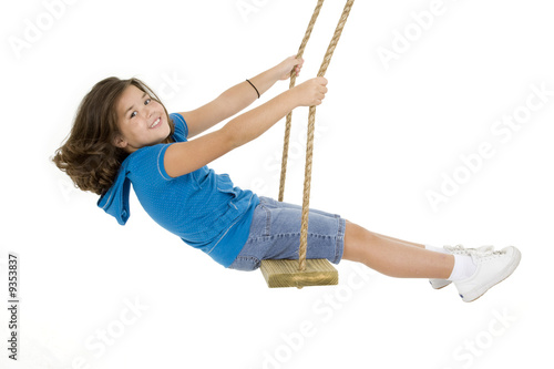 Caucasian child playing on a swing on white background