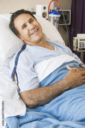Middle Aged Man Lying In Hospital Bed