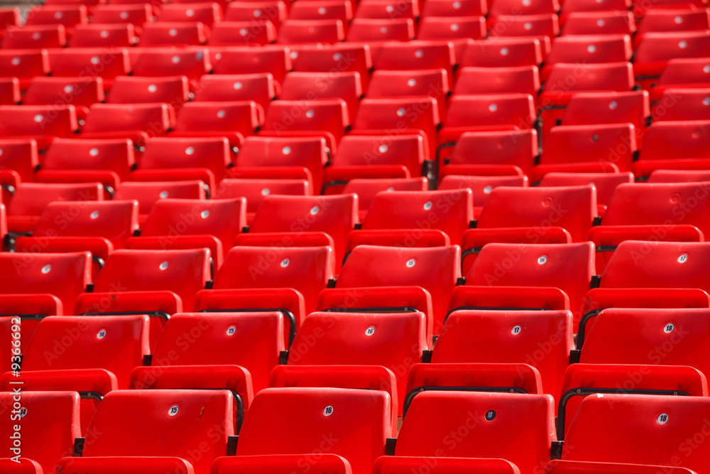 many plastic red seat in deserted stadium many plastic red seat in deserted stadium